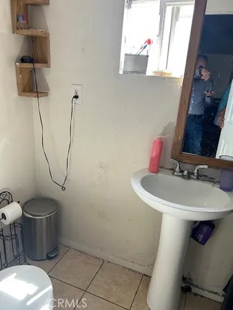 a bathroom with a sink toilet and a mirror