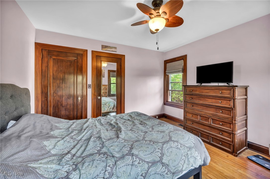7550 Mayfield Road Chesterland, OH 44026 - Photo 25 of 45 Bedroom with light wood-style flooring and ceiling fan