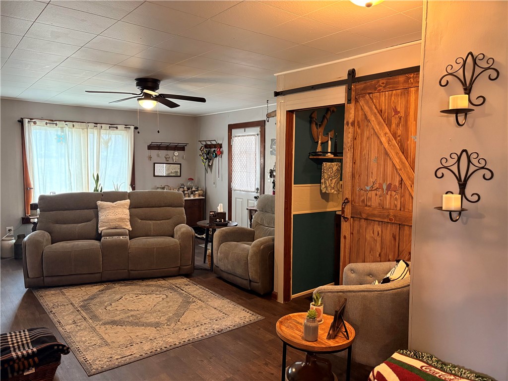 321 Liberty Street Eaton, OH 45320 - Photo 22 of 34 This inviting living space features warm flooring and a charming barn door, perfect for relaxed gatherings.