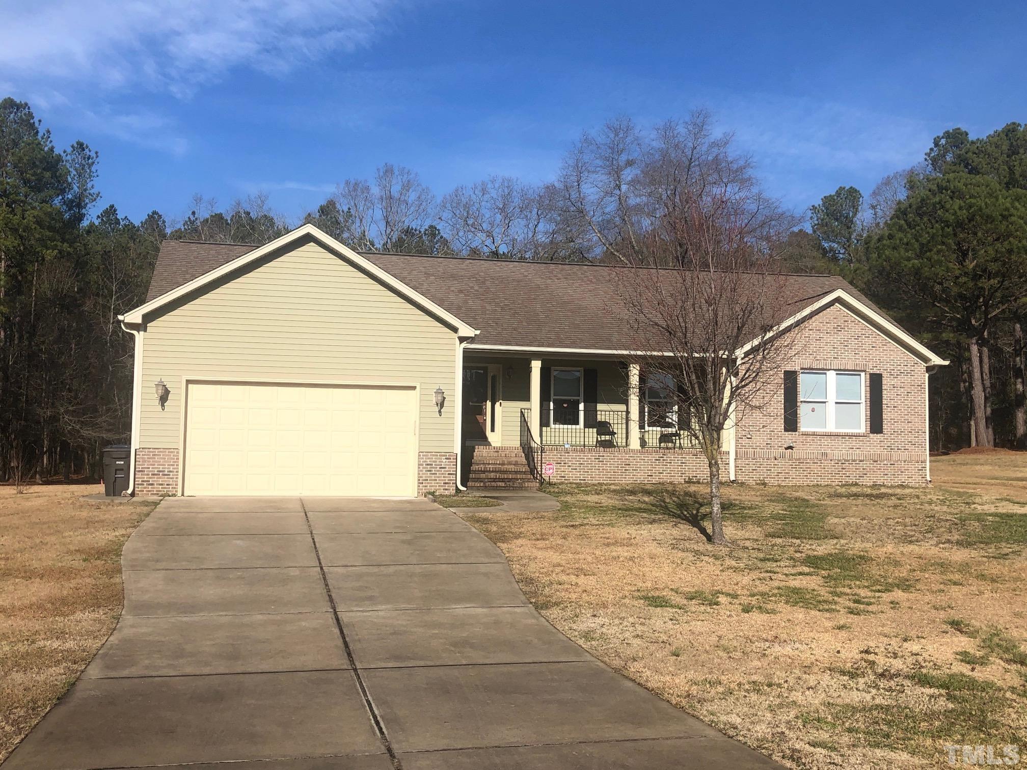 770 Cross Link Drive Angier, NC 27501 - Photo 1 of 23 a front view of a house with a yard and garage