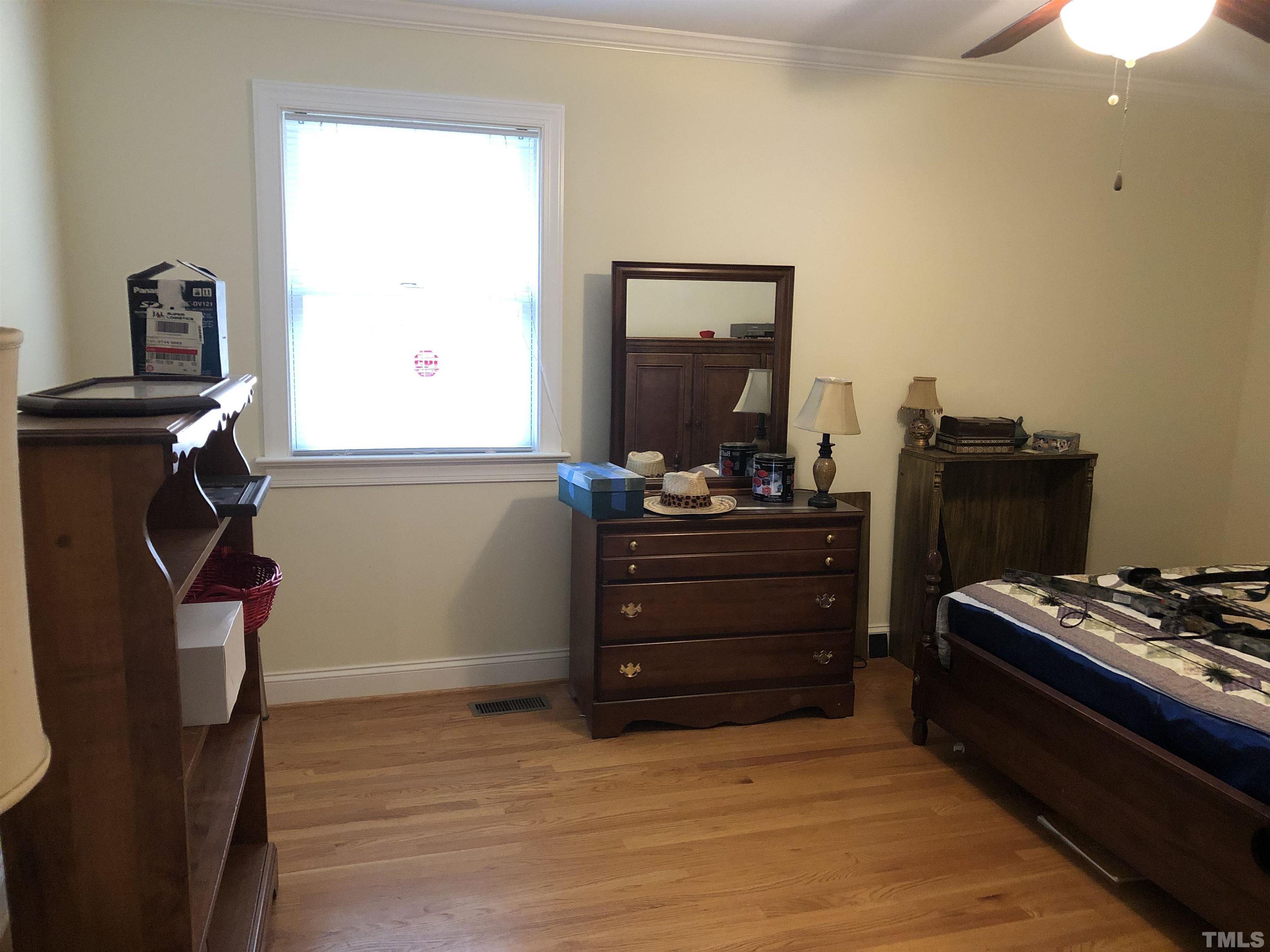 770 Cross Link Drive Angier, NC 27501 - Photo 15 of 23 a bedroom with a bed and a mirror
