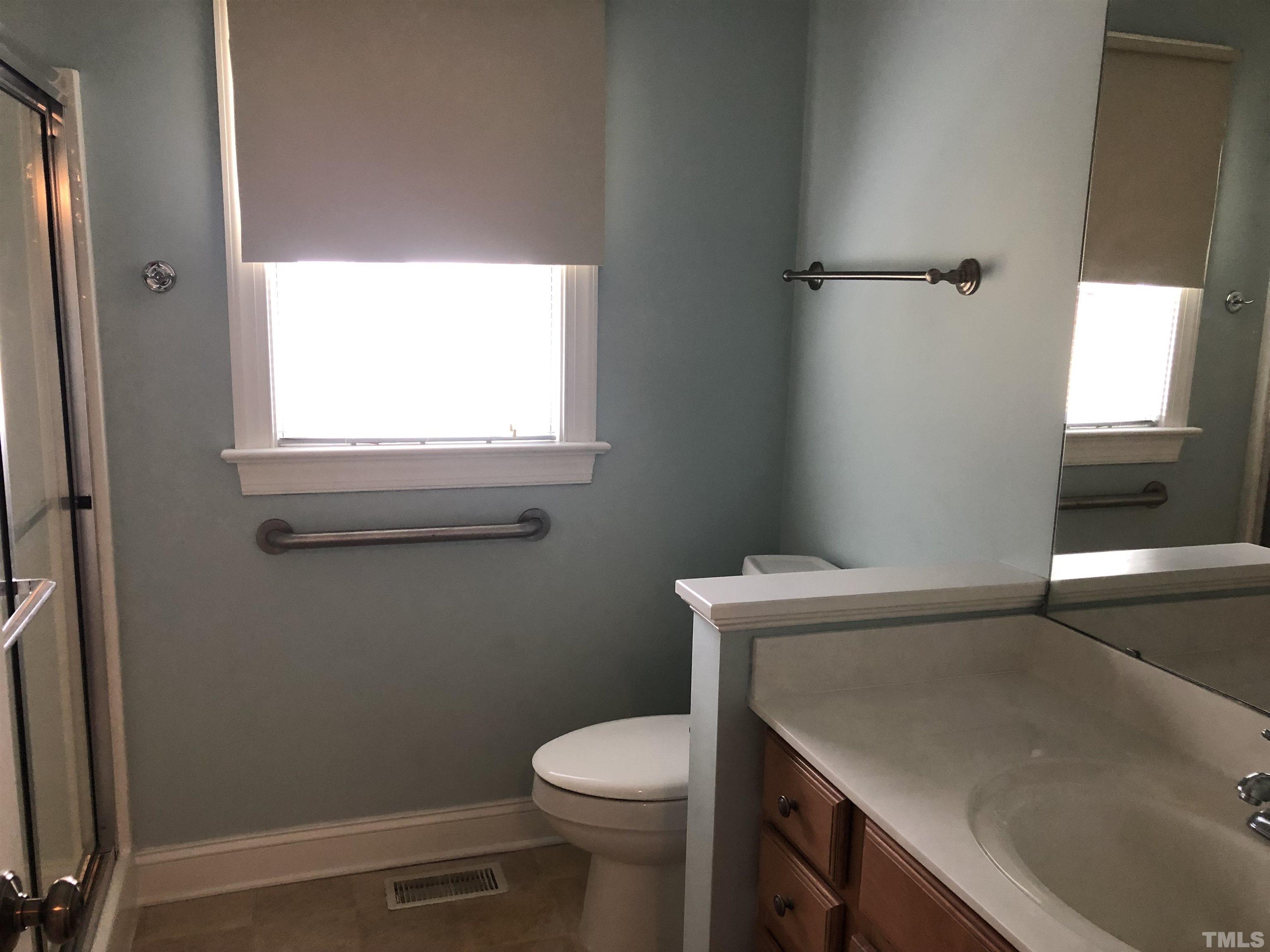 770 Cross Link Drive Angier, NC 27501 - Photo 16 of 23 a bathroom with a sink a toilet and window
