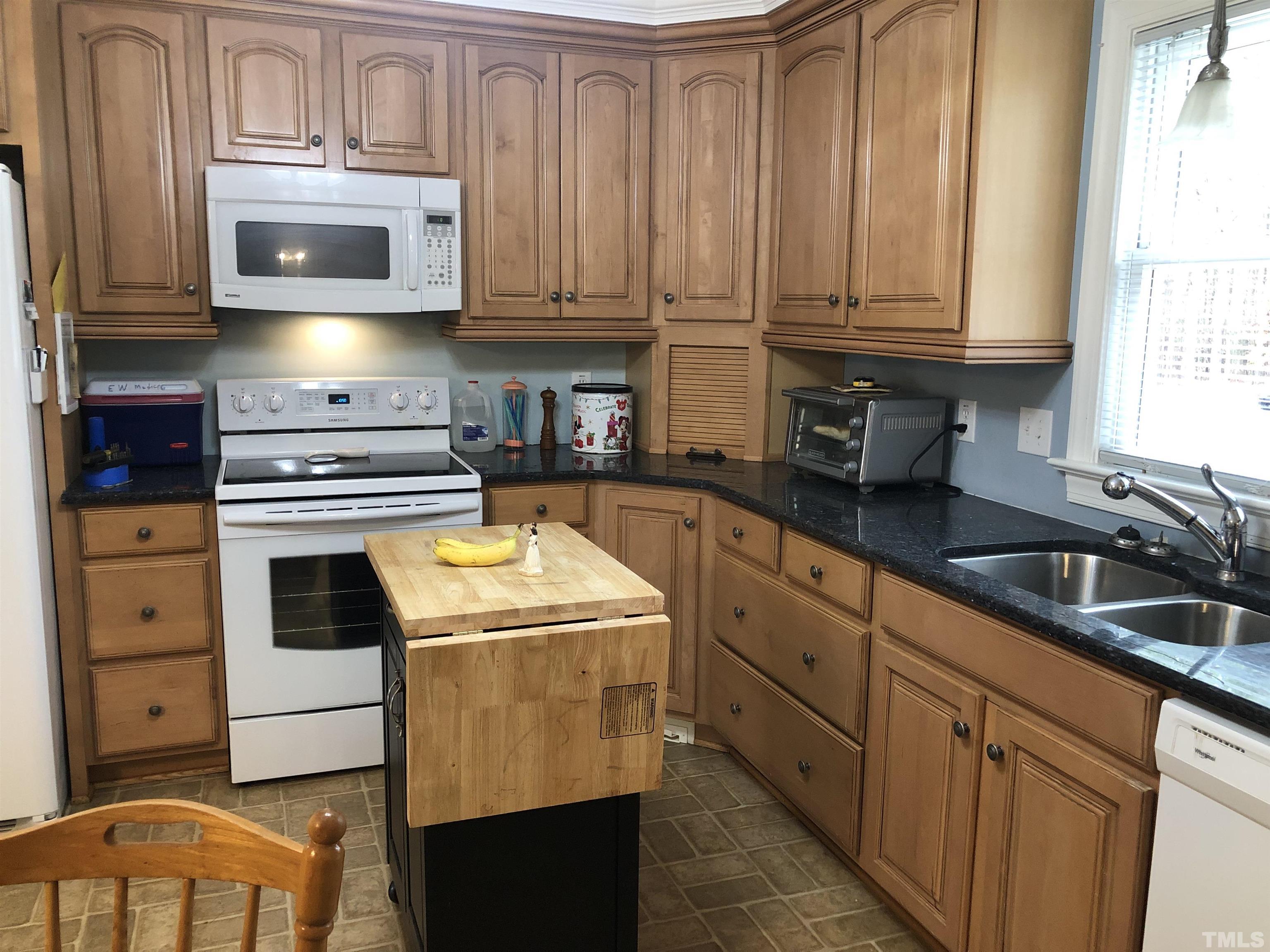 770 Cross Link Drive Angier, NC 27501 - Photo 2 of 23 a kitchen with granite countertop cabinets stainless steel appliances and a sink