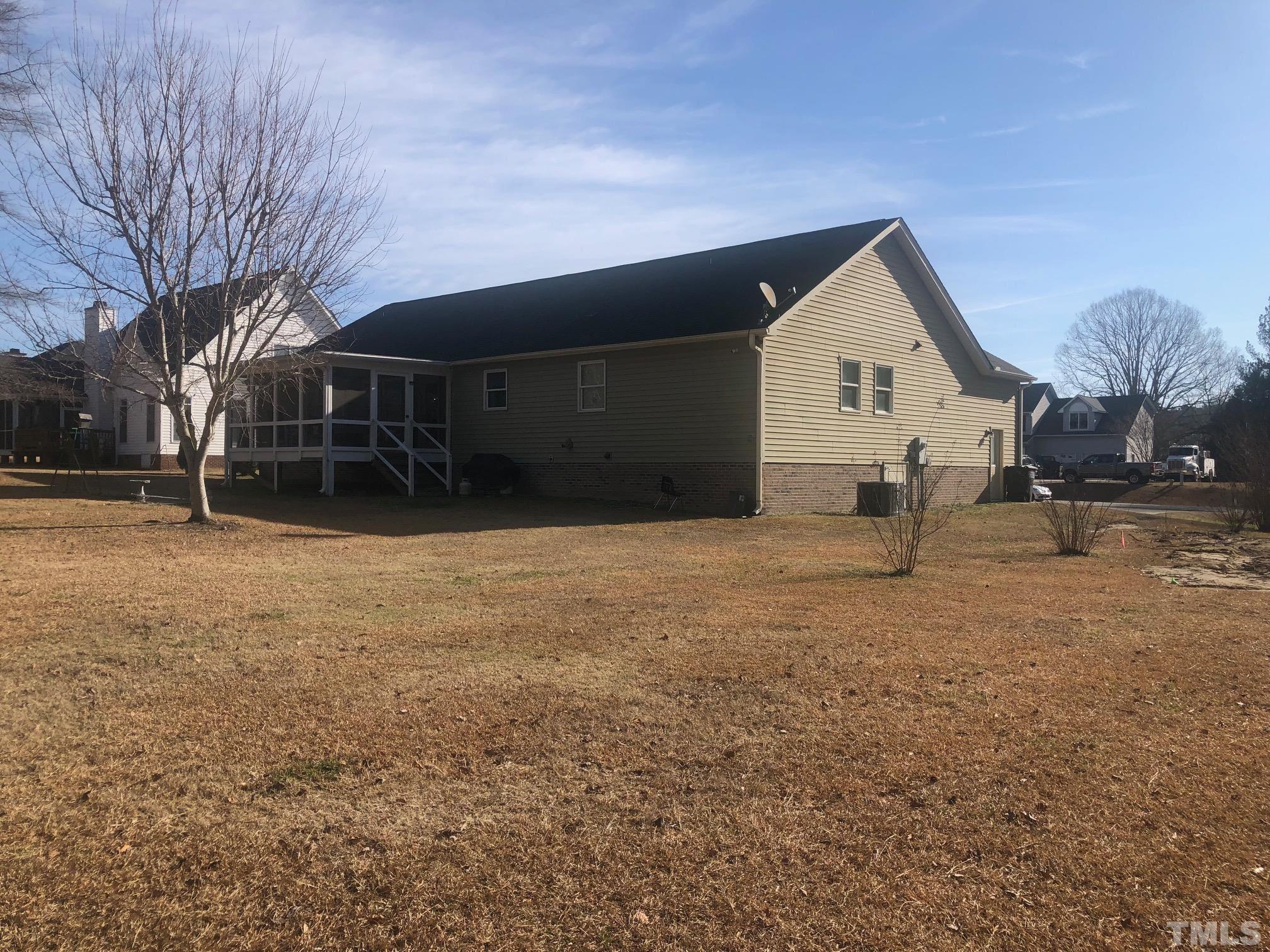 770 Cross Link Drive Angier, NC 27501 - Photo 21 of 23 a backyard of a house with plants and large tree