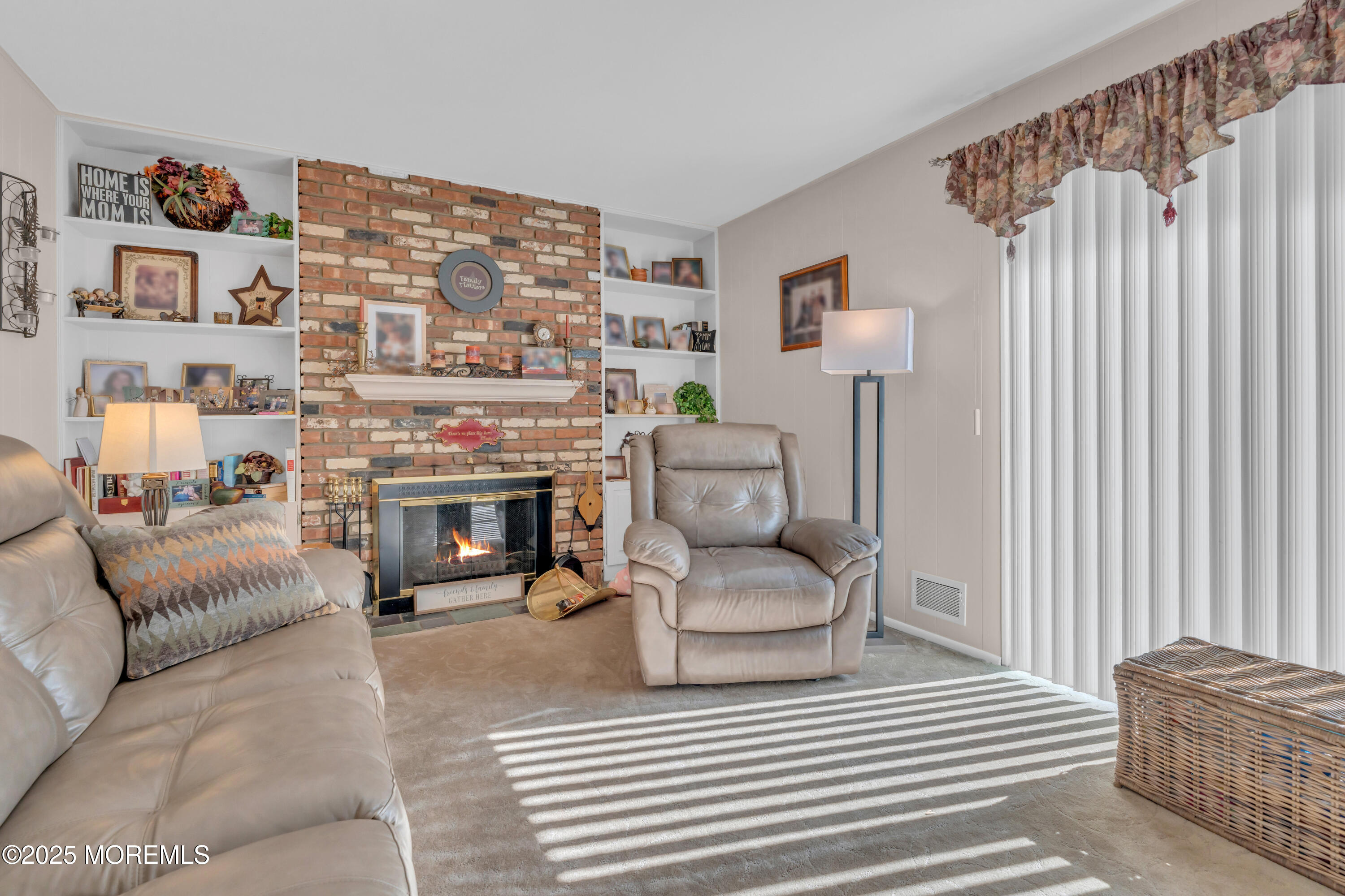 232 Bar Harbor Road Freehold, NJ 07728 - Photo 13 of 42 a living room with furniture a fireplace and a flat screen tv