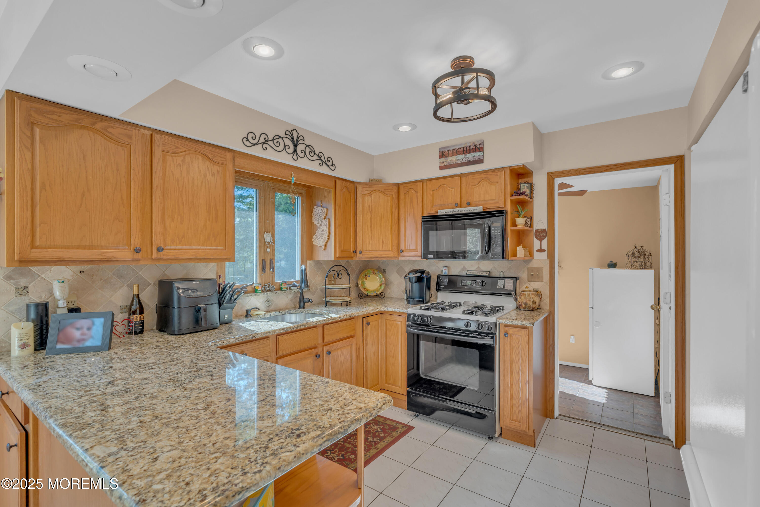 232 Bar Harbor Road Freehold, NJ 07728 - Photo 5 of 42 a kitchen with stainless steel appliances granite countertop a stove top oven a refrigerator a sink and dishwasher