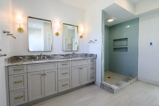 a bathroom with a granite countertop sink mirror and double