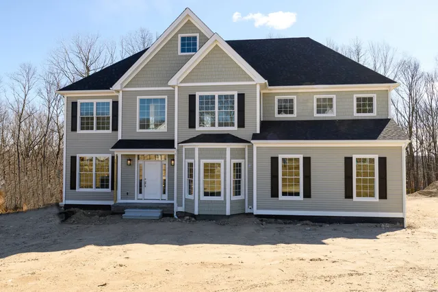 a front view of a house with a yard