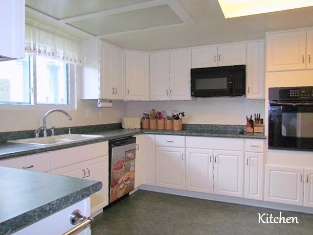 6710 North Applegate Road Grants Pass, OR 97527 - Photo 7 of 33 a kitchen with granite countertop white cabinets sink and stainless steel appliances
