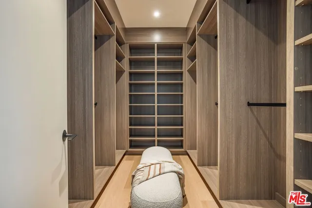 a view of walk in closet with empty room