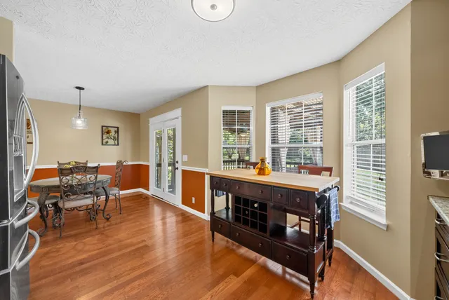 a view of a hallway with wooden floor and entryway