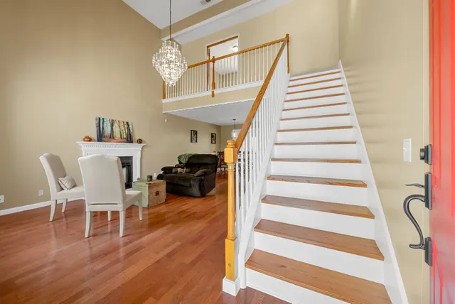 a living room with furniture a fireplace and wooden floor