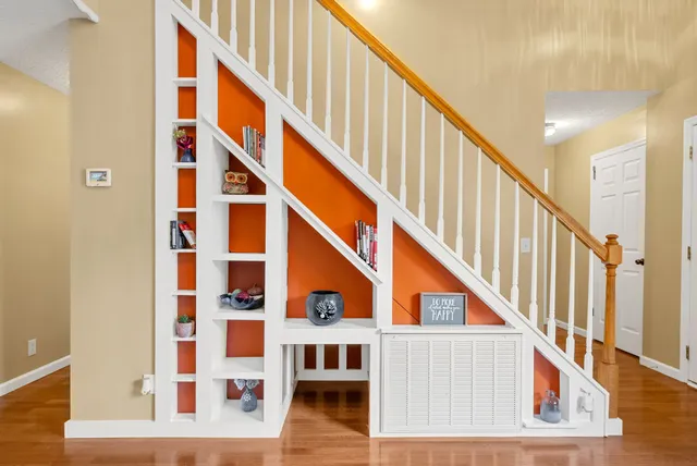 a dining room with furniture a chandelier and wooden floor