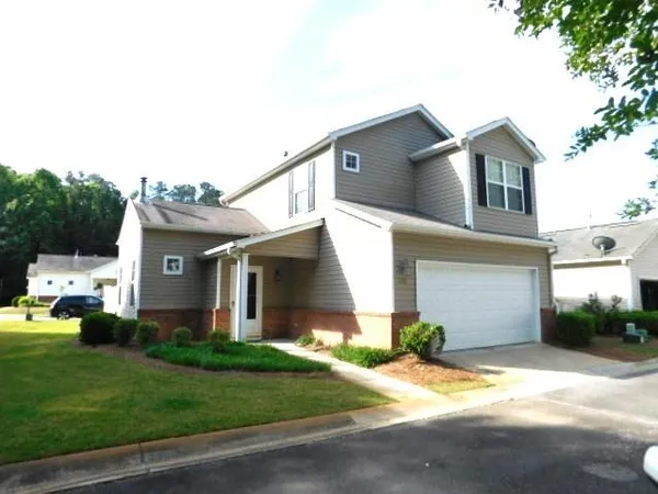a front view of house with yard and green space