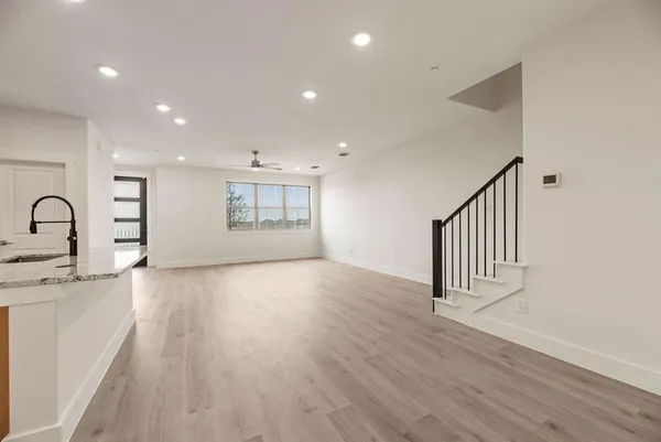 a view of a room with wooden floor and window