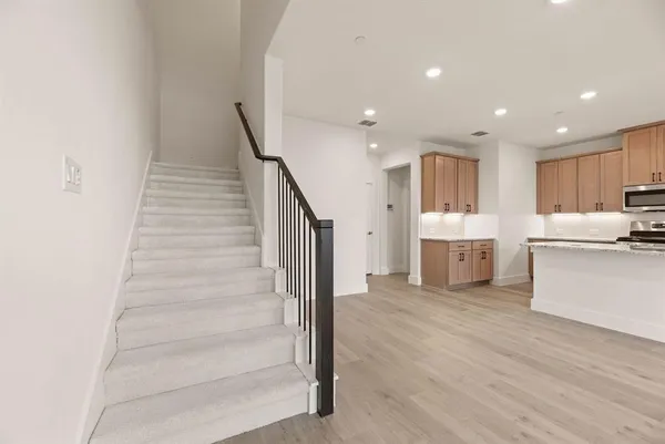 a view of a kitchen with wooden floor and electronic appliances