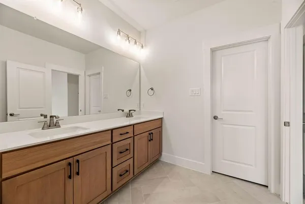 a spacious bathroom with a double vanity sink double and mirror