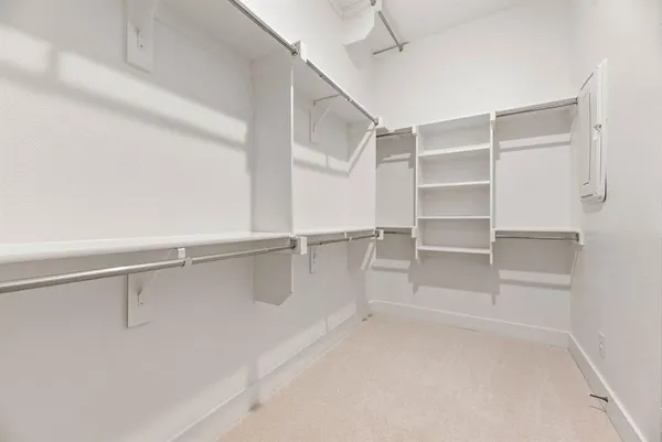 a view of walk in closet with empty racks