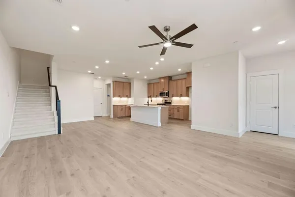 a view of a kitchen with a sink and dishwasher a refrigerator with wooden floor