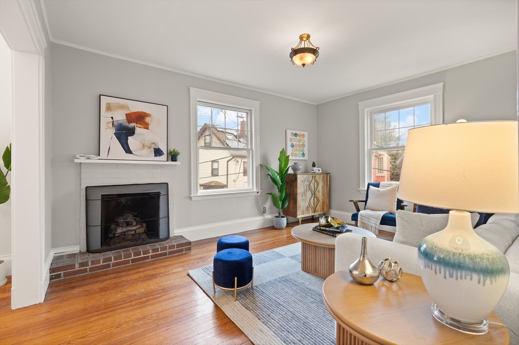 60 Crescent Street, Unit 2 Cambridge, MA 02138 - Photo 1 of 23 a living room with furniture a fireplace and a potted plant