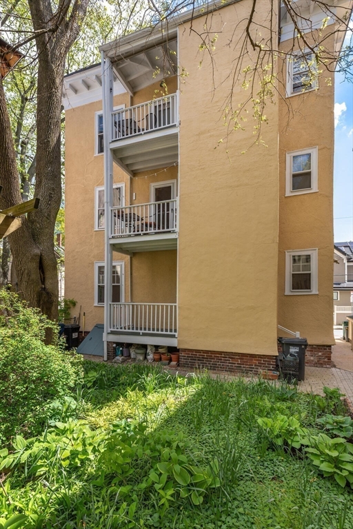 60 Crescent Street, Unit 2 Cambridge, MA 02138 - Photo 20 of 23 a view of a house with a small yard and wooden fence