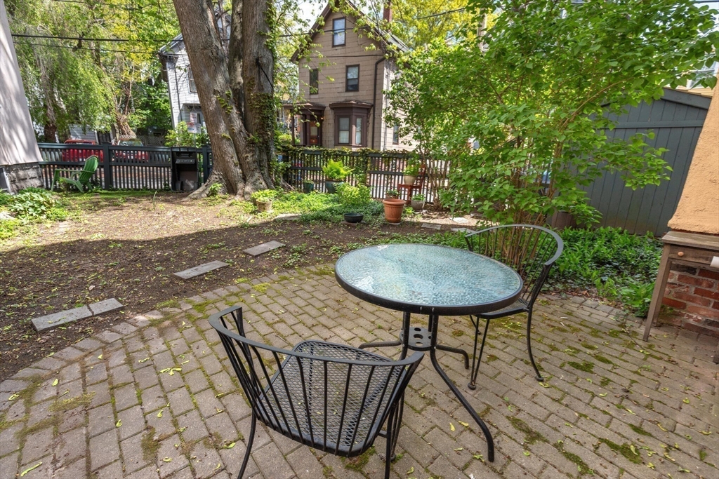 60 Crescent Street, Unit 2 Cambridge, MA 02138 - Photo 22 of 23 a view of a chairs and table in backyard of the house