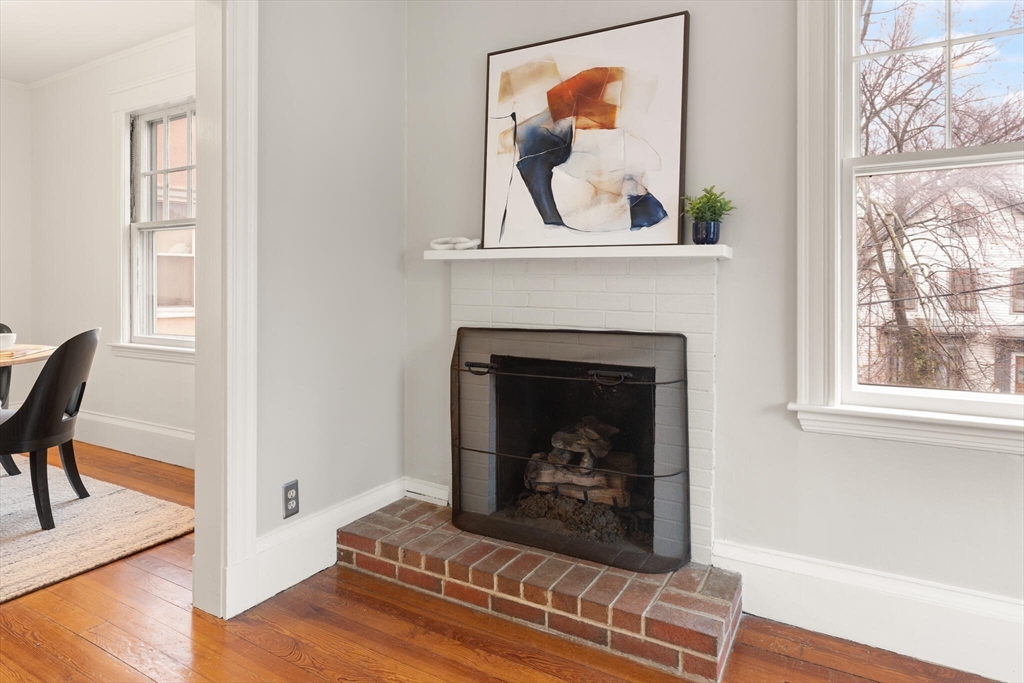60 Crescent Street, Unit 2 Cambridge, MA 02138 - Photo 5 of 23 a living room with a fireplace and a window