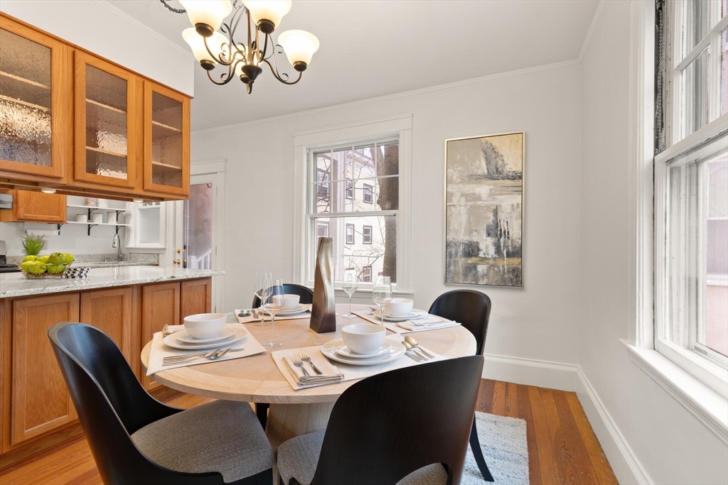 60 Crescent Street, Unit 2 Cambridge, MA 02138 - Photo 6 of 23 a dining room with furniture a rug and wooden floor