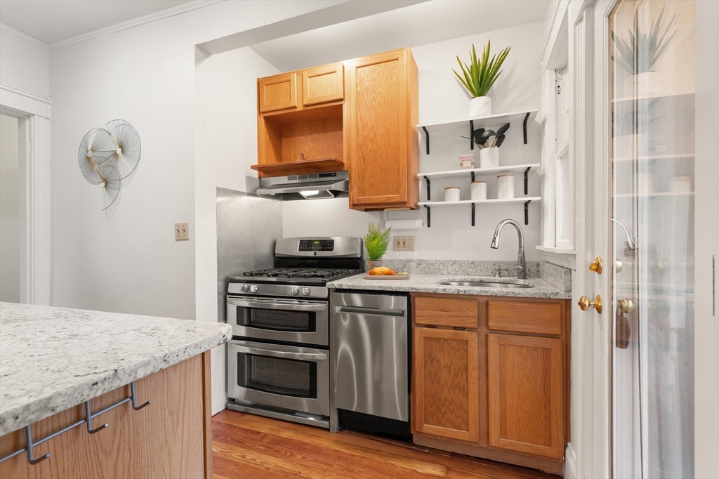 60 Crescent Street, Unit 2 Cambridge, MA 02138 - Photo 8 of 23 a kitchen with stainless steel appliances granite countertop a stove and a sink