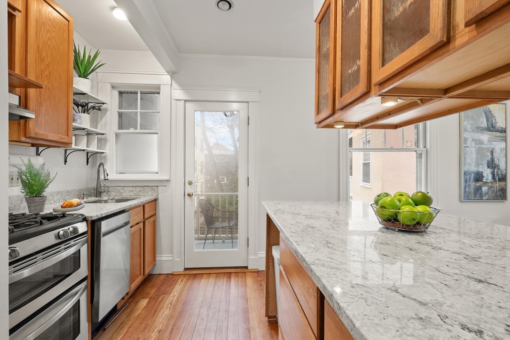 60 Crescent Street, Unit 2 Cambridge, MA 02138 - Photo 9 of 23 a kitchen with stainless steel appliances granite countertop a sink a stove and cabinets