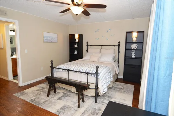 a bedroom with a bed and a mirror