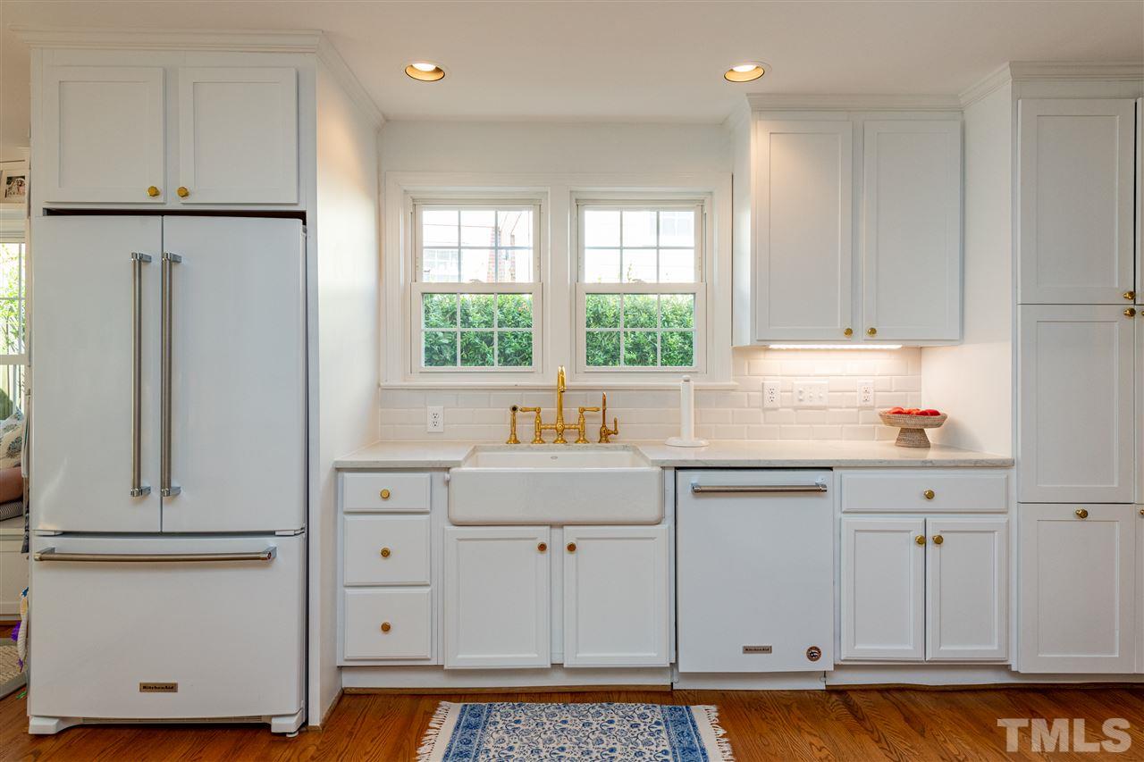 2705 Cooleemee Drive Raleigh, NC 27608 - Photo 11 of 30 The white cabinets, quartz counter tops, and timeless backsplash create a a clean look!