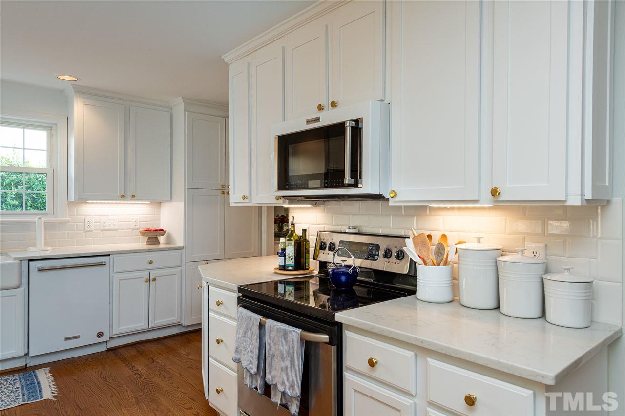 2705 Cooleemee Drive Raleigh, NC 27608 - Photo 12 of 30 The microwave and dishwasher were updated to blend in nicely with the cabinetry.