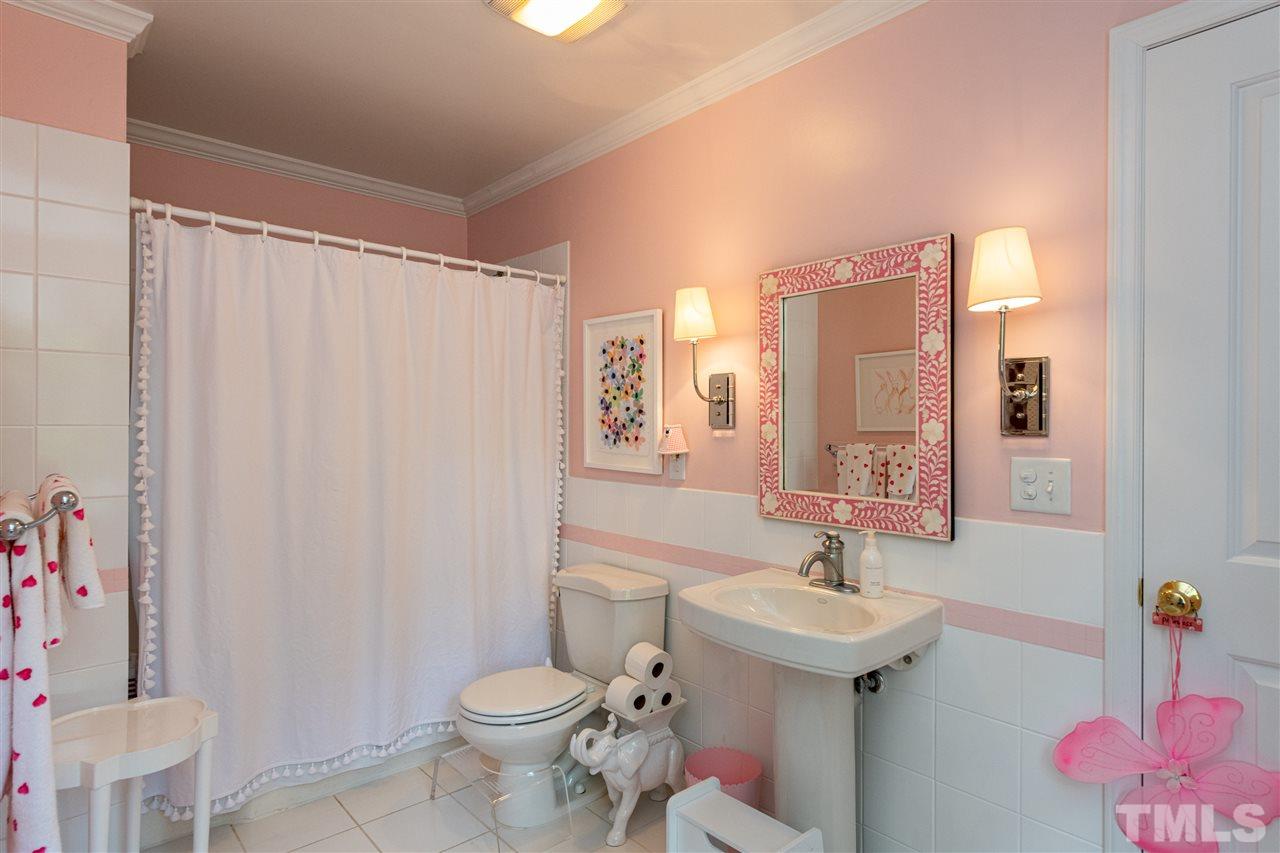 2705 Cooleemee Drive Raleigh, NC 27608 - Photo 21 of 30 The Jack and Jill bathroom is well proportioned and serves the 2nd and 3rd bedrooms upstairs.