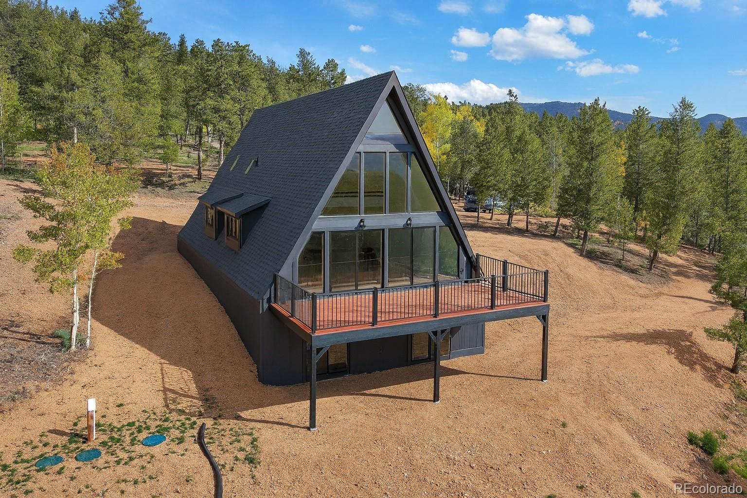 a roof deck with table and chairs