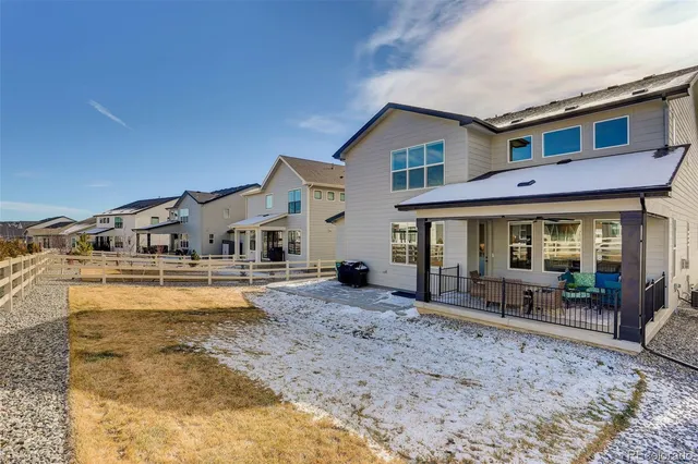a front view of a house with swimming pool and furniture