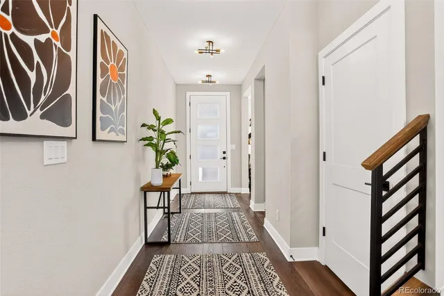 a hallway with wooden floor and entryway