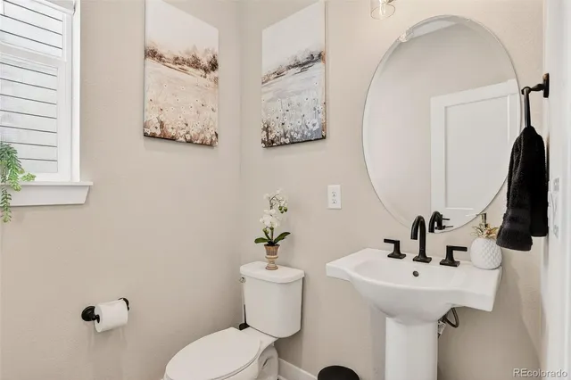 a bathroom with a sink mirror and toilet