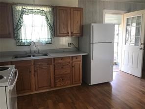 1414 Woodward Street Damon, TX 77430 - Photo 5 of 5 a kitchen with a refrigerator and a sink