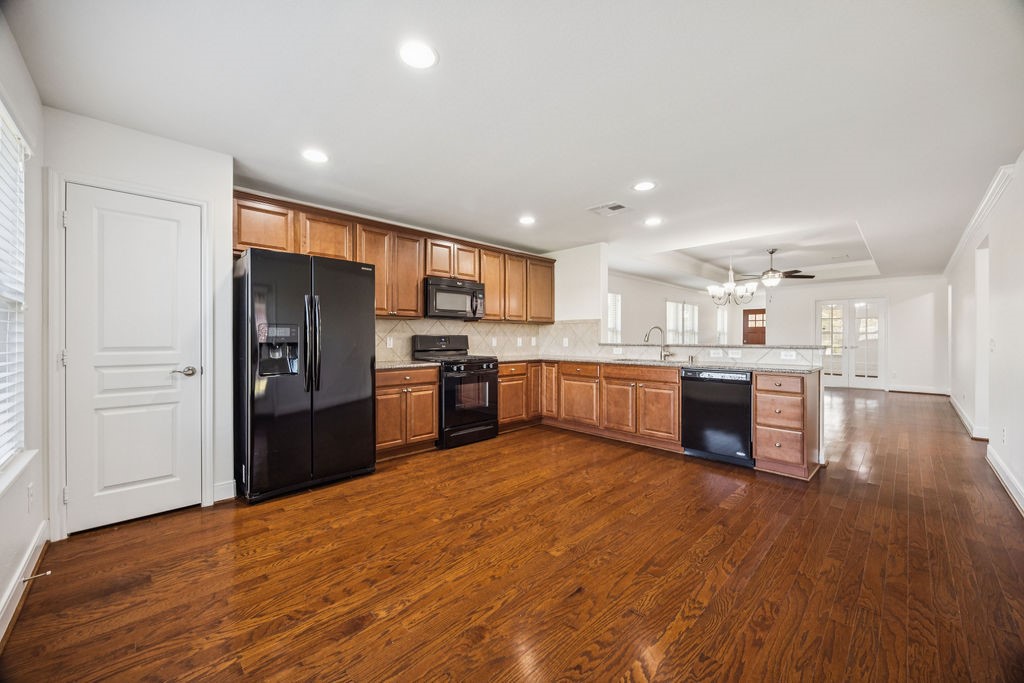 342 Ranch House Lane Richmond, TX 77469 - Photo 6 of 17 a kitchen with a refrigerator and a sink