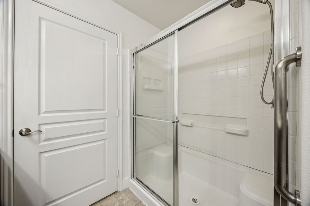 342 Ranch House Lane Richmond, TX 77469 - Photo 10 of 17 a bathroom with a glass shower door