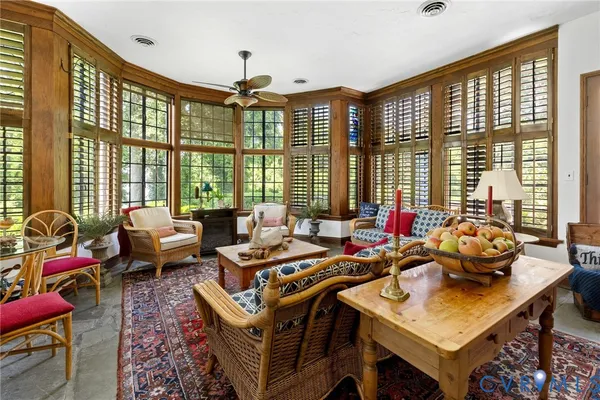 a living room with furniture rug and window