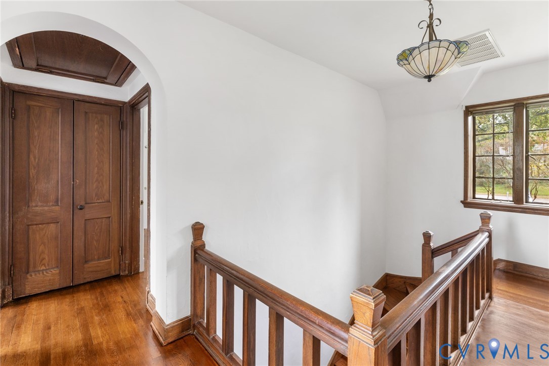 701 Appomattox Street Hopewell, VA 23860 - Photo 19 of 32 a view of a hallway with wooden floor and staircase
