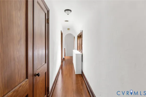 a view of a yard with potted plants and large trees