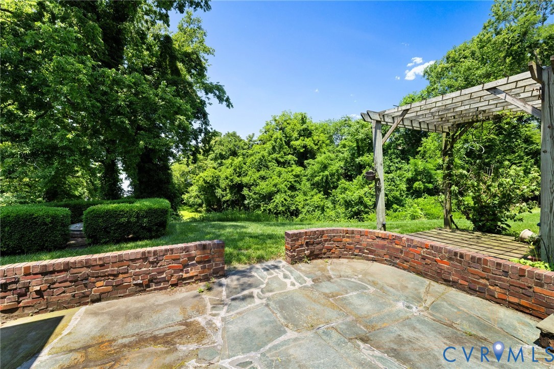 701 Appomattox Street Hopewell, VA 23860 - Photo 24 of 32 a view of a yard with potted plants and large trees