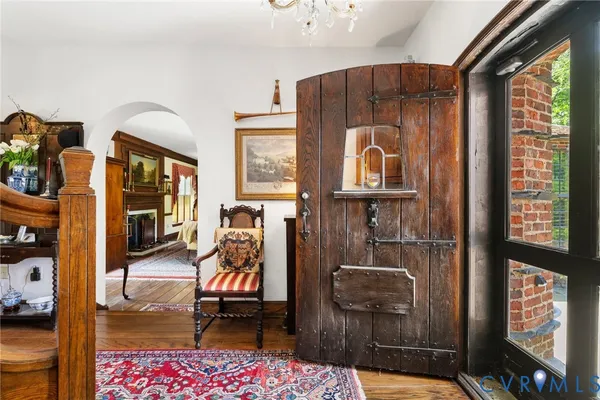 a living room with furniture a fireplace and a floor to ceiling window