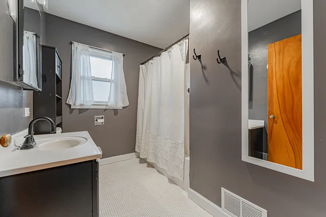 a bathroom with a sink a mirror and shower