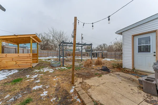 a backyard of a house with table and chairs