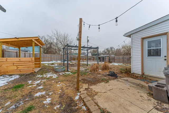 a backyard of a house with table and chairs