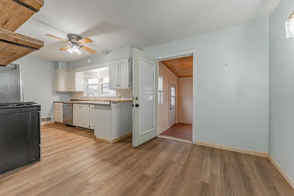 a view of a kitchen with a sink and cabinet
